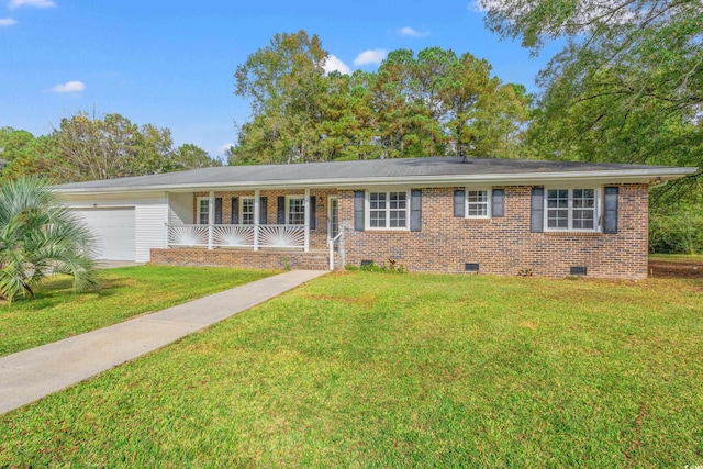 ranch-style home featuring a front lawn, covered porch, and a garage