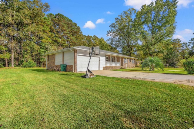 view of front of property featuring a garage, covered porch, and a front yard