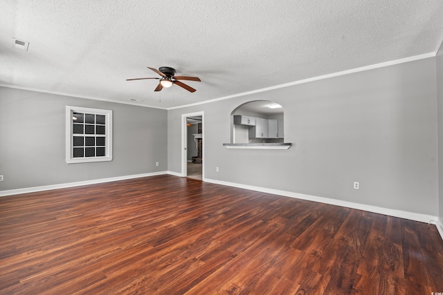 unfurnished room featuring ceiling fan, dark wood-type flooring, a textured ceiling, and ornamental molding