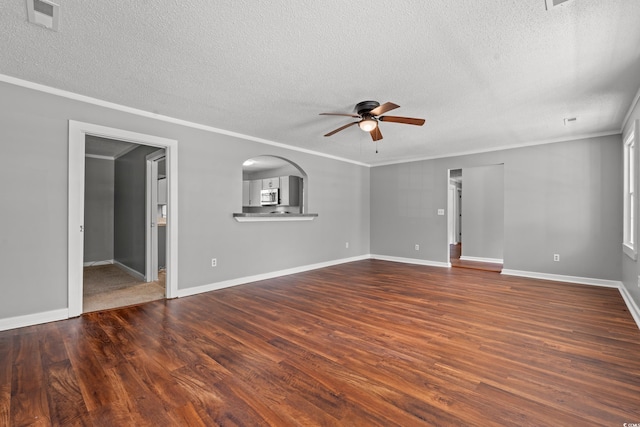 interior space featuring a textured ceiling, ceiling fan, dark hardwood / wood-style floors, and ornamental molding