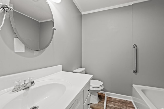 bathroom with hardwood / wood-style floors, toilet, a bathtub, vanity, and ornamental molding