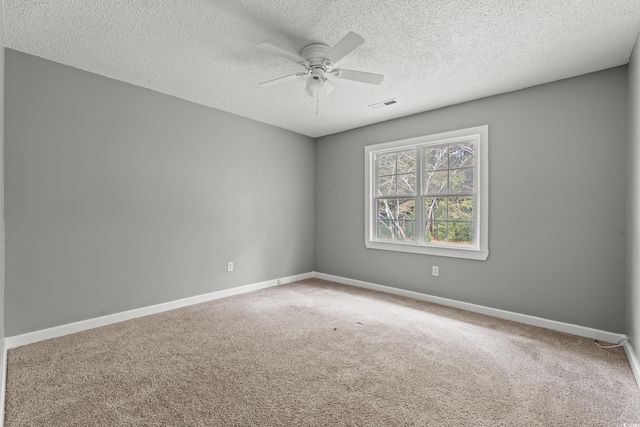 unfurnished room featuring ceiling fan, carpet, and a textured ceiling