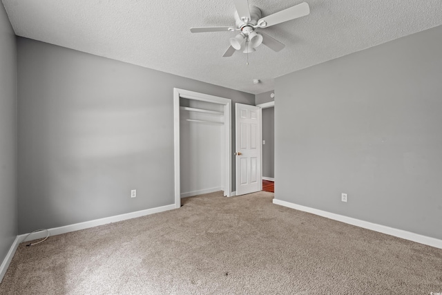 unfurnished bedroom featuring ceiling fan, a closet, carpet, and a textured ceiling