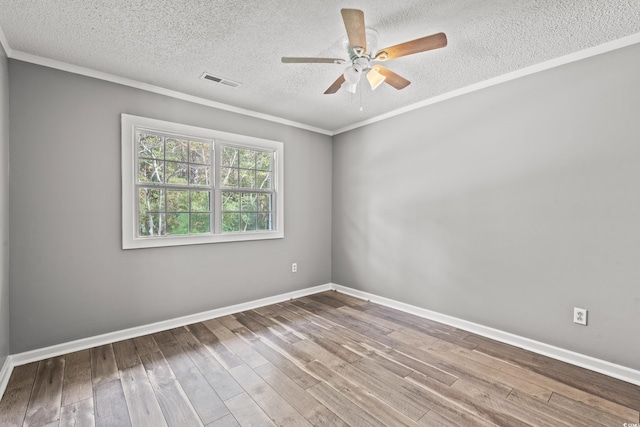 unfurnished room featuring hardwood / wood-style floors, crown molding, and a textured ceiling