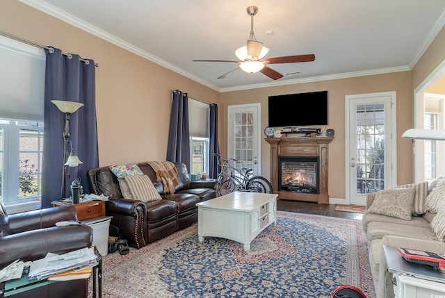 living room featuring ceiling fan, wood-type flooring, and ornamental molding