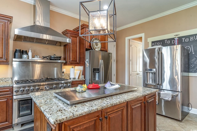 kitchen featuring a center island, wall chimney range hood, crown molding, high quality appliances, and light tile patterned floors