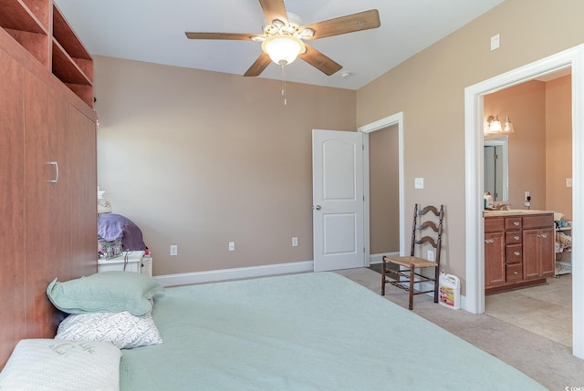 bedroom featuring connected bathroom, ceiling fan, and light carpet