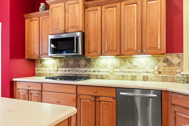 kitchen with stainless steel appliances and tasteful backsplash