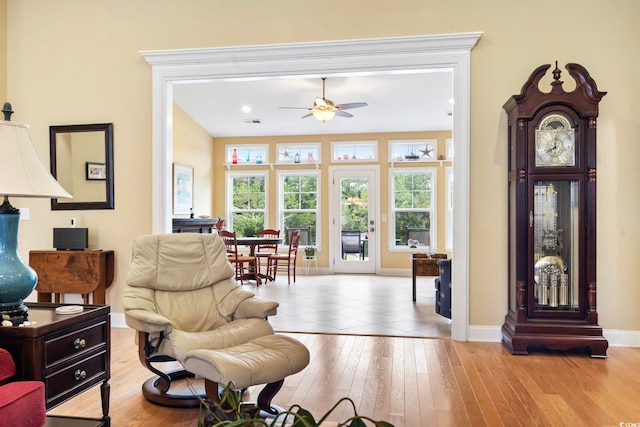 living area featuring ceiling fan and light hardwood / wood-style flooring