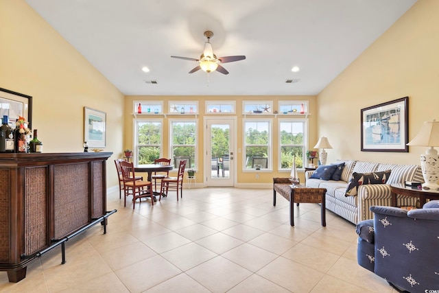 living room with vaulted ceiling, ceiling fan, and plenty of natural light