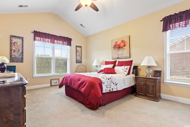 carpeted bedroom featuring ceiling fan, multiple windows, and lofted ceiling