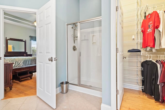 bathroom featuring wood-type flooring and an enclosed shower