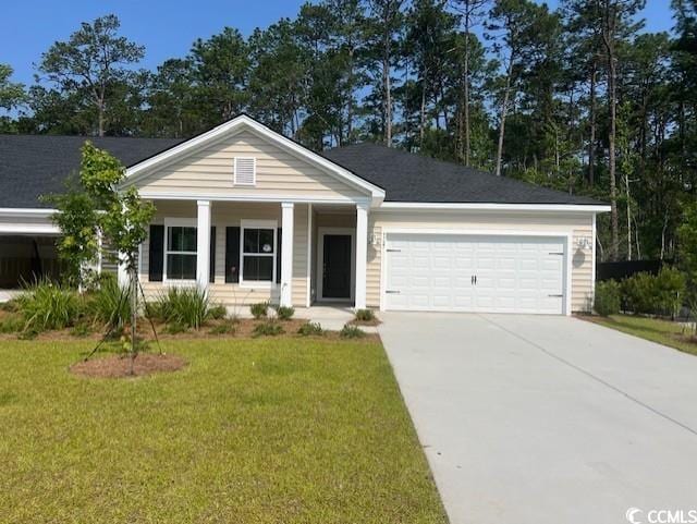 9727 Indigo Creek Blvd, Murrells Inlet, SC 29576 - view of front of home featuring covered porch, an attached garage, driveway, and a front yard