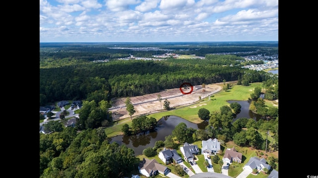 aerial overview of property's location with a large body of water, a heavily wooded area, a golf course, and nearby suburban area