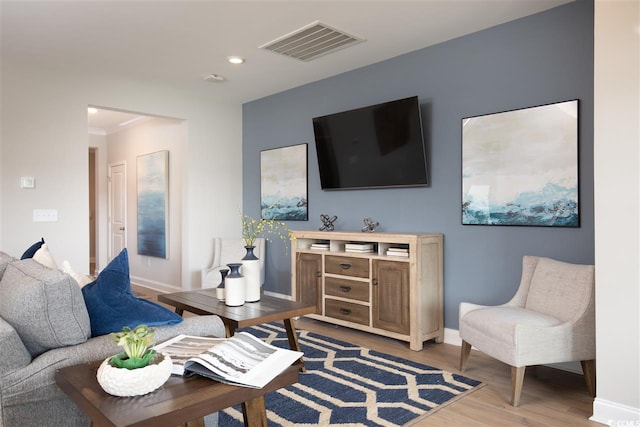 living area featuring wood finished floors, baseboards, and recessed lighting