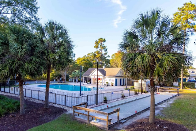 community pool with a game area and fence