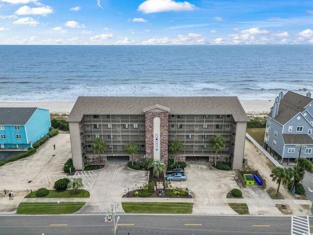 drone / aerial view featuring a beach view and a water view