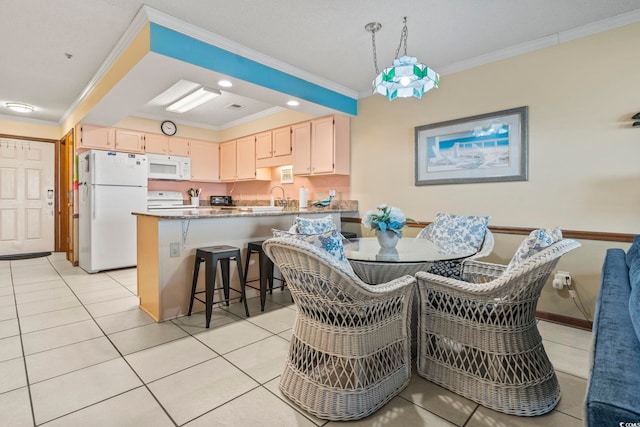 dining area with ornamental molding, light tile patterned floors, and sink