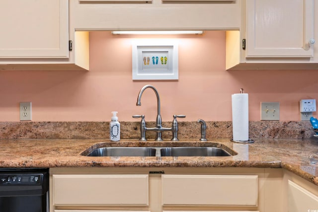 kitchen with white cabinets, dishwasher, and light stone countertops