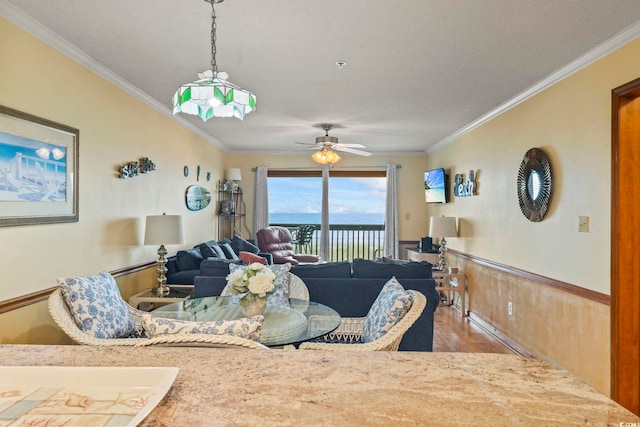 living room featuring ceiling fan, hardwood / wood-style floors, and ornamental molding