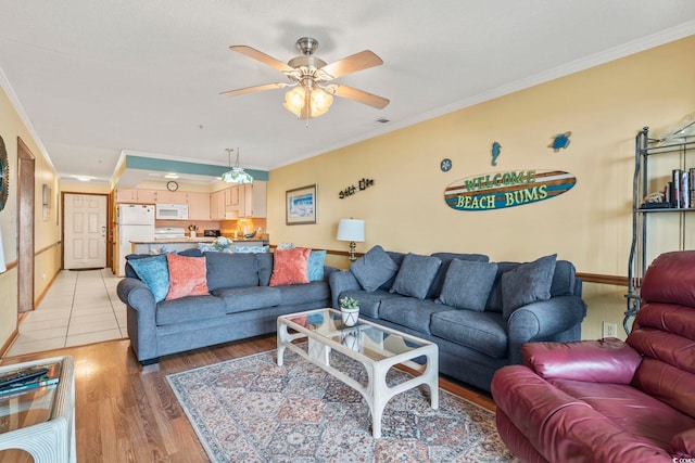 living room featuring ceiling fan, light hardwood / wood-style floors, and ornamental molding