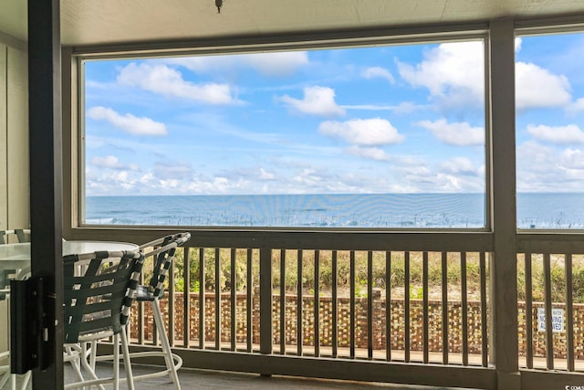 unfurnished sunroom featuring a water view