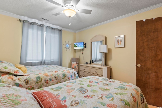 bedroom with ornamental molding, a textured ceiling, and ceiling fan