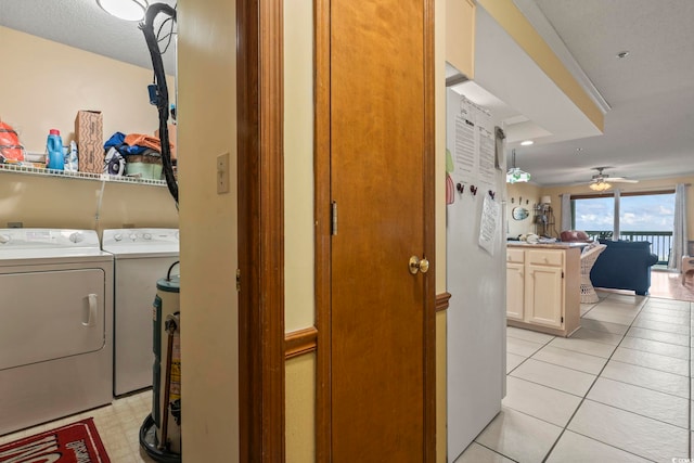 laundry area featuring ceiling fan, a textured ceiling, light tile patterned floors, and independent washer and dryer