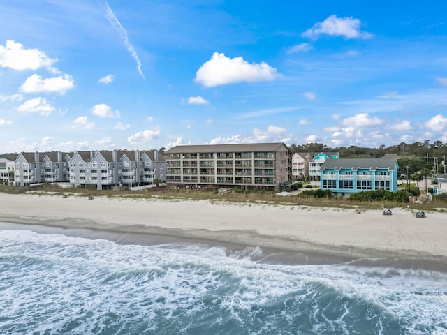 birds eye view of property with a view of the beach and a water view