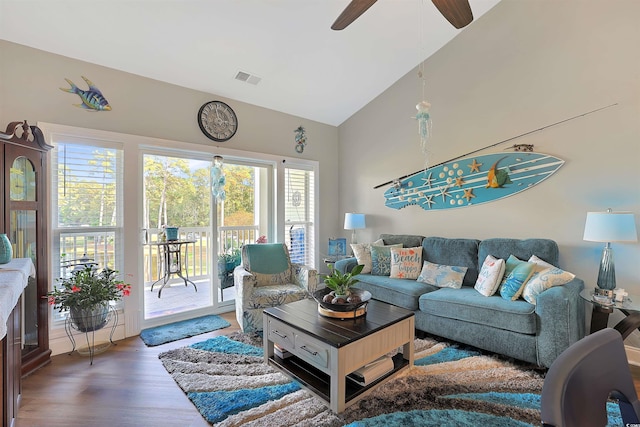 living room with ceiling fan, high vaulted ceiling, and dark hardwood / wood-style flooring