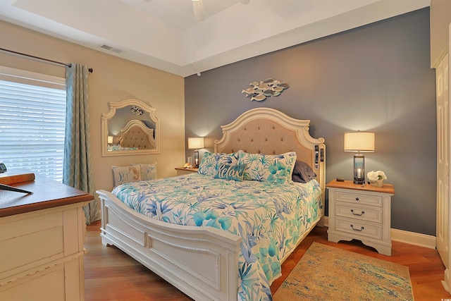 bedroom with dark wood-type flooring and ceiling fan