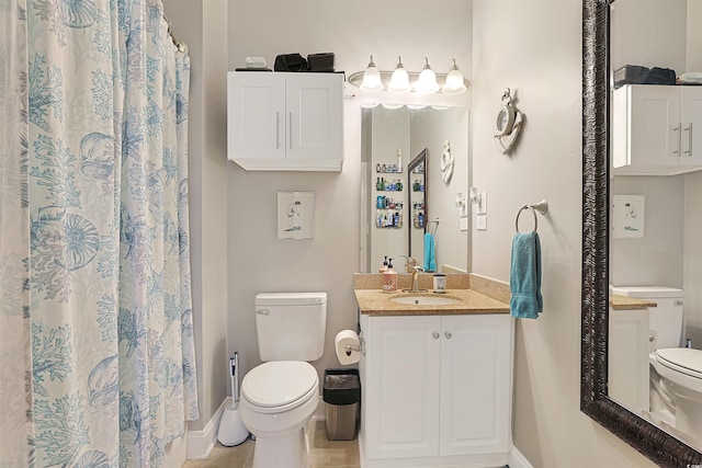 bathroom with vanity, tile patterned floors, and toilet