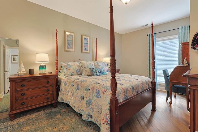 bedroom with dark hardwood / wood-style flooring