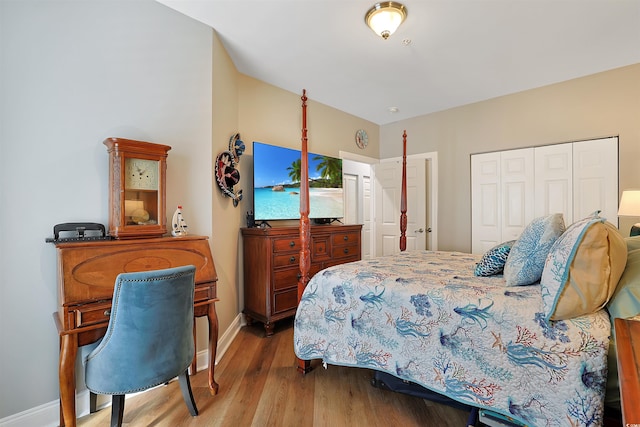 bedroom with light wood-type flooring and a closet