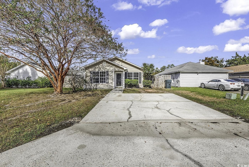 ranch-style home featuring a front yard