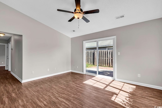 spare room featuring dark wood-type flooring, ceiling fan, a textured ceiling, and vaulted ceiling