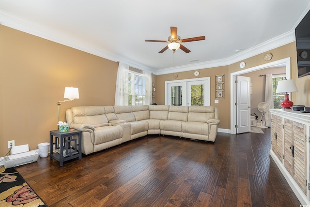 living room featuring dark wood-type flooring, a wealth of natural light, and ornamental molding