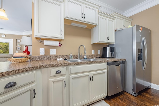 kitchen featuring ornamental molding, appliances with stainless steel finishes, decorative light fixtures, sink, and dark wood-type flooring