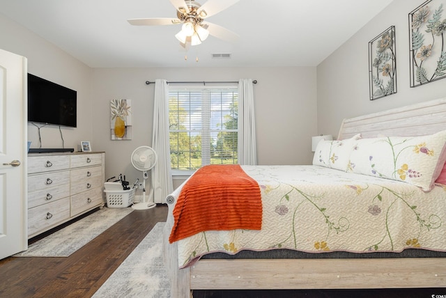 bedroom with ceiling fan and dark hardwood / wood-style floors