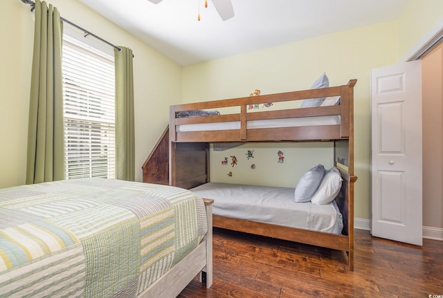 bedroom with dark hardwood / wood-style flooring and ceiling fan