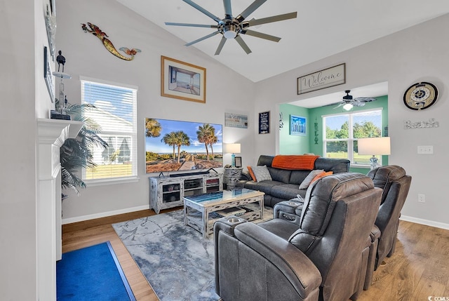 living room featuring a wealth of natural light, ceiling fan, vaulted ceiling, and hardwood / wood-style flooring