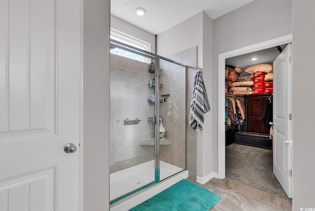 bathroom featuring walk in shower and tile patterned flooring