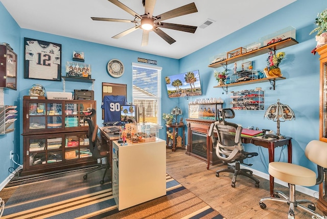 office space featuring light wood-type flooring and ceiling fan