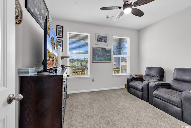 cinema room with light colored carpet and ceiling fan