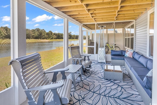 sunroom / solarium featuring a water view