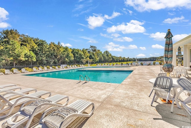 view of swimming pool with a patio