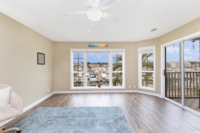 unfurnished sunroom featuring ceiling fan