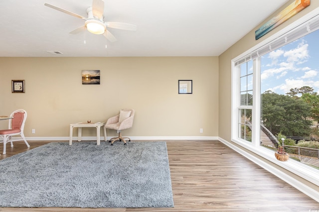 sitting room with ceiling fan and light hardwood / wood-style flooring