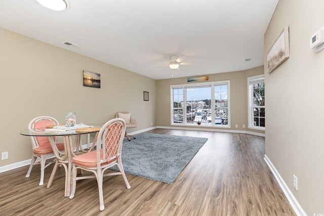 dining room featuring wood-type flooring and ceiling fan