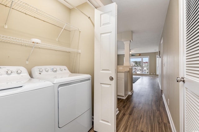 laundry area with dark wood-type flooring and washing machine and dryer